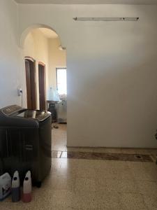 an empty room with a large white wall at Traveler rest in Arbājīyah