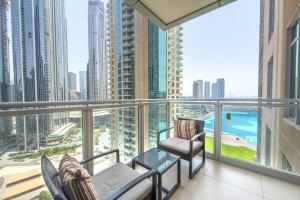 a balcony with chairs and a view of the city at Ramada by Wyndham Downtown Dubai in Dubai