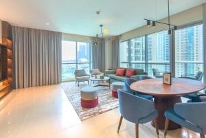 a living room with a table and chairs at Ramada by Wyndham Downtown Dubai in Dubai