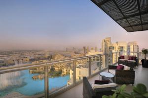a balcony with chairs and a view of a city at Ramada by Wyndham Downtown Dubai in Dubai