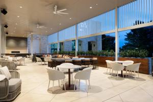a restaurant with tables and chairs and large windows at Grand Hyatt San Antonio River Walk in San Antonio