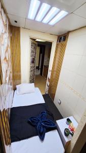 a bedroom with two beds with a blue bow at Cozy Beyond Simple in Abu Dhabi