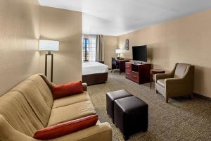 a hotel room with a couch and a bed at Comfort Inn Benson near Kartchner Caverns in Benson