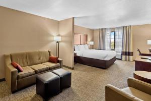 a hotel room with a bed and a couch at Comfort Inn Benson near Kartchner Caverns in Benson +28 photos