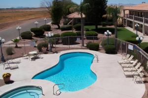 a swimming pool in a courtyard with chairs at Quality Inn Casa Grande I-10 in Casa Grande
