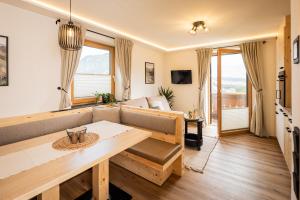 a living room with a couch and a table at Grillhofer - Slow Living Apartments -LUNGAUCard inkludiert in Mauterndorf