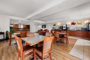 a dining room with wooden tables and chairs at Quality Inn Battleboro - Rocky Mount in Battleboro