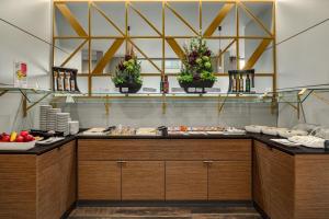 a buffet line with fruits and vegetables on display at Ramada by Wyndham Essen in Essen