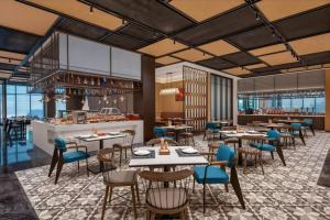 a rendering of a restaurant with tables and chairs at Wyndham Garden Datong Ancient City in Datong