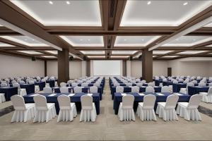 a large room with rows of tables and chairs at Wyndham Garden Datong Ancient City in Datong