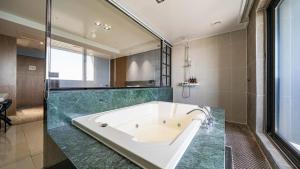 a large bathroom with a tub and a shower at Incheon Grace Hotel in Incheon +11 photos