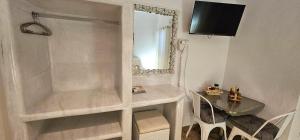 a bathroom with a mirror and a table and a mirror at Santorini Studios Pleasure in Perissa +104 photos