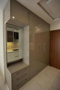 a bathroom with a shower with a glass door at ZAR Luxury Suites in Murree +85 photos