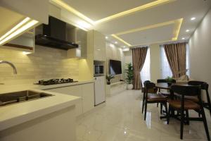 a kitchen and dining room with a table and chairs at ZAR Luxury Suites in Murree