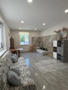 a living room with a couch and a table at Butas pačiame miesto centre in Telšiai