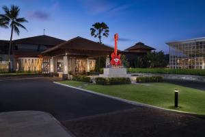 a building with a statue in the middle of a yard at Hard Rock Hotel Bali in Kuta