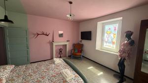 a bedroom with a bed and a window and a chair at Verde Salvia House in Corniglio