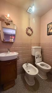 a bathroom with a toilet and a sink and a mirror at Verde Salvia House in Corniglio +19 photos