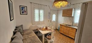 a living room with a couch and a table at Pleasure Blackbeach Studios in Perissa