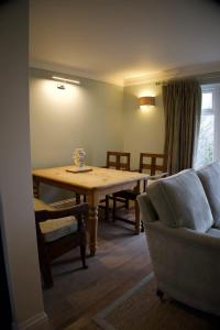 a living room with a table and a couch at Badgers Bolt in Avington