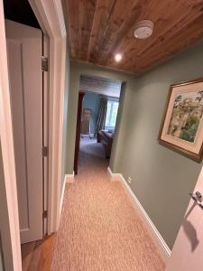 a hallway with green walls and a wooden ceiling at Badgers Bolt in Avington +19 photos