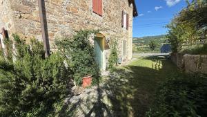 a brick building with a door and a plant at Verde Salvia House in Corniglio