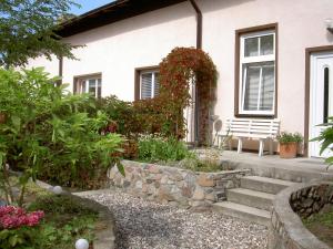 a house with a stone wall and stairs in front at Hotel Gesellschaftshaus in Bergen auf Rügen