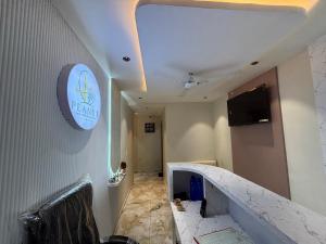 a room with a staircase with a sign on the wall at Hotel Planet Town in Ahmedabad
