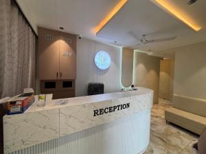 a lobby with a reception counter in a building at Hotel Planet Town in Ahmedabad