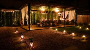 a patio with a table and lights at night at Casa TEOS in 2 Mai