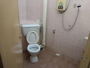 a bathroom with a toilet and a shower at VKB Ferringhi Styles Penang formerly Grand Star Hotel in Batu Ferringhi +17 photos