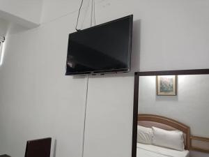 a flat screen tv hanging on a wall at VKB Ferringhi Styles Penang formerly Grand Star Hotel in Batu Ferringhi