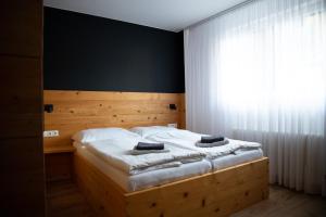 a bedroom with a large bed with a large window at Penzion Sabina in Vernár +94 photos