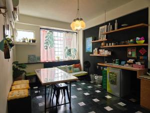 a kitchen with a table and a counter top at Avery case in Tainan