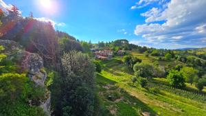 an aerial view of a field with a house on a hill at Guest House Panorama in Gela