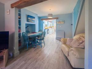 a living room with a couch and a table at Penny Cottage in Heacham