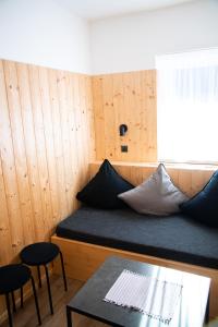 a room with a bed with a window and a table at Penzion Sabina in Vernár