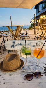 a table with two drinks and a hat and glasses at Casa TEOS in 2 Mai