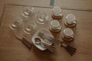 a table with plates and forks and wine glasses at o ku in Awaji