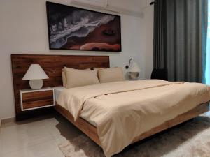 a bedroom with a large bed and two lamps at Villa 80 in Gonapola +20 photos