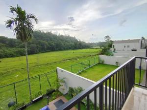 a balcony with a view of a field at Villa 80 in Gonapola