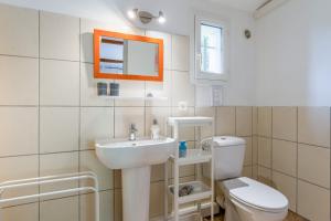 a bathroom with a sink and a toilet at Chambres D'hôtes Les Seignerolles in Pernes-les-Fontaines +25 photos