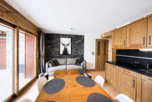 a kitchen with a wooden table in a room at Chalet Adele - Appartement 4 personnes situé en bord de piste St Martin de Belleville MAE-5684 in Saint-Martin-de-Belleville