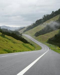 an empty road in the middle of a mountain at Rumavin Homestay, Seremban in Seremban