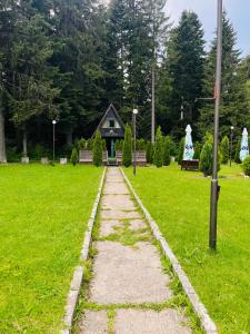 a stone path leading to a building in a park at Chalet Musala in Borovets