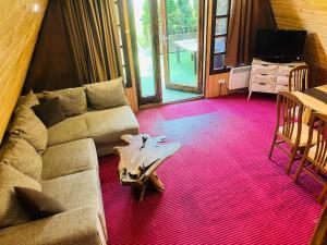 a living room with a couch and a table at Chalet Musala in Borovets +9 photos