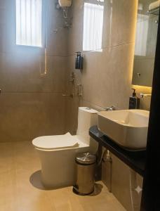 a bathroom with a toilet and a sink at Hotel 5 Elements By Fidato Hotels in Akalkot