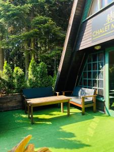 a group of benches sitting outside of a building at Chalet Musala in Borovets