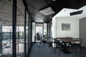 an office with a table and chairs and windows at Qubus Hotel Zielona Góra in Zielona Góra
