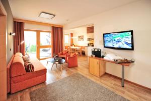 a living room with a couch and a flat screen tv at Chesa Arella in Serfaus